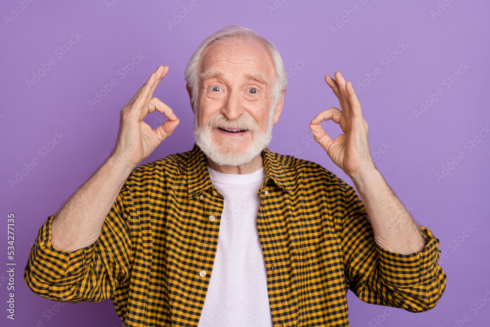 Poster Photo of cheerful grandpa grey hair show okey approval symbol dressed stylish yellow shirt isolated on lilac purple color background