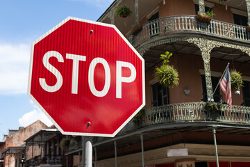 Stop Sign along a Street in the French Quarter of New Orleans with Old Buildings in the Background