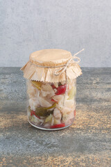 One jar full of salty vegetables on sackcloth