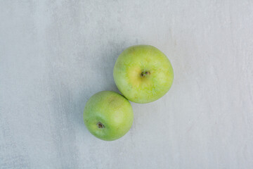 Fresh green apples on stone background
