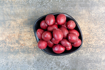 A dark plate of delicious fruits on white background