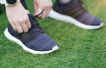 woman wearing run shoes tie shoelace on backyard selective focus