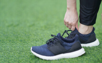 woman wearing run shoes in lawn