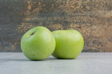 Fresh green apples on stone table