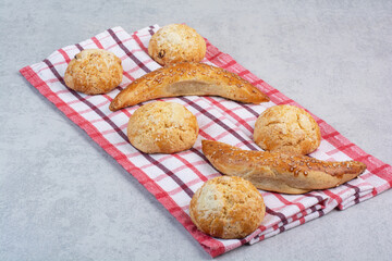 Variety of sweet biscuits on striped tablecloth