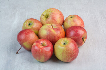 Bunch of fresh apples on stone background