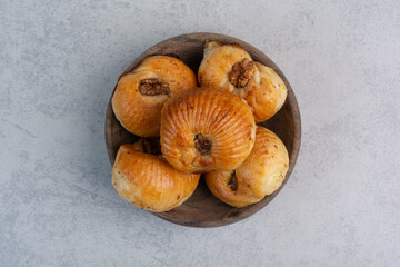Sweet biscuits with walnut kernels in wooden bowl