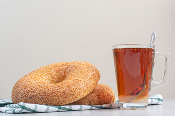 Simit with sesame seeds and glass of tea