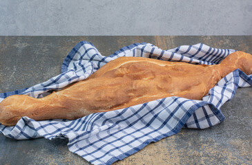Hot homemade bread on striped tablecloth