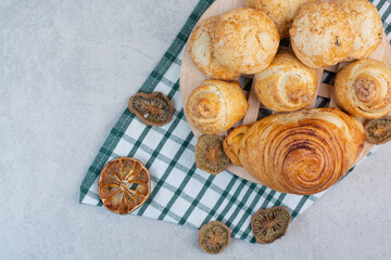 Variety of sweet biscuits on wooden piece with dried fruits