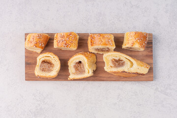 Bunch of sweet cookies on wooden plate