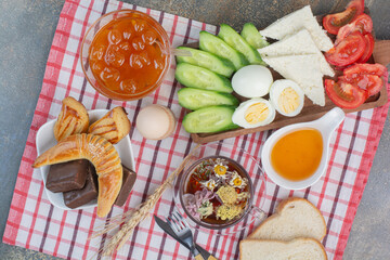 Breakfast table with food, desserts and tea