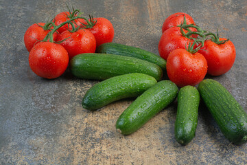 Bunch of tomatoes and cucumbers on marble background