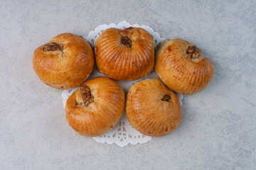 Sweet biscuits with walnut kernels on gray background