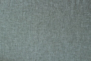 Natural linen background. Gray, pale green color dyed linen organic eco textiles canvas background. Top view