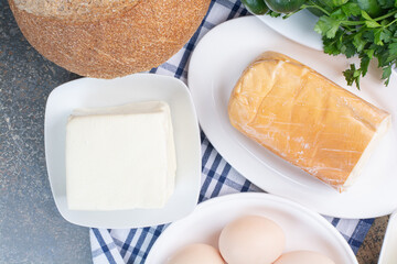 Boiled eggs and various cheese on plates
