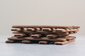 Stack of stick biscuits on gray background
