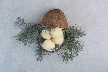 Fototapeta na wymiar Coconut cookies inside coconut on gray background