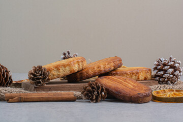 Homemade biscuits on wooden board with pinecones