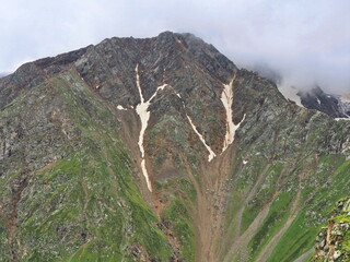 Mountain slopes of the Elbrus region with snow, glaciers and clouds. Elbrus region,...