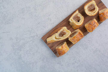 Bunch of sweet cookies on wooden plate