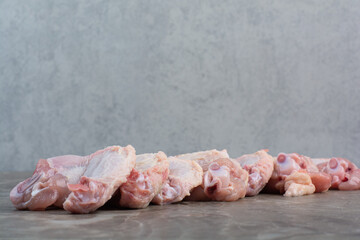 Uncooked chicken legs on marble background