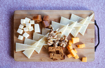assorted cheese board with quince jelly, nuts and toasted bread
