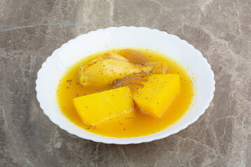 Tasty soup with chicken meat and potato on white plate