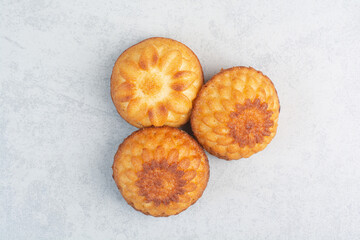 Sweet delicious cupcakes on white background