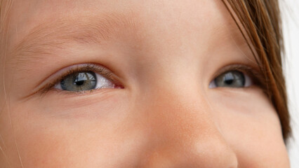 Close-up of beautiful childs eyes looking into the distance