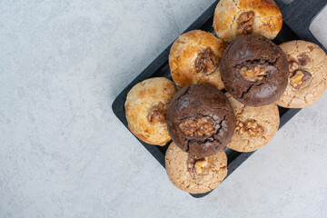 Round fresh delicious cookies on dark plate