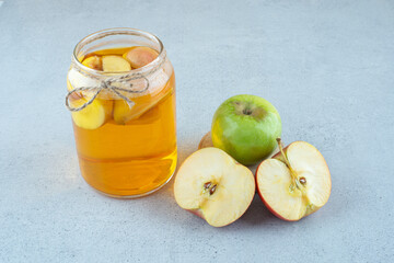 Apple juice and fresh apples on blue background