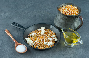 Ingredients for preparing homemade popcorn on marble background