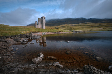 A old castle on the shore mountain lake. Ardvreck Castle on the shore of Loch Assynt, north west...