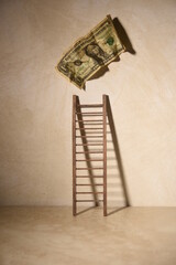 ladder with dollar bill peeling off wall