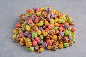 Candy coated popcorn heaped up on marble background