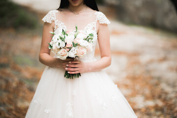 Luxury wedding bride, girl posing and smiling with bouquet