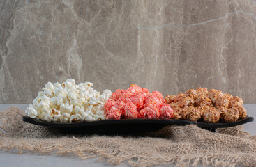 A popcorn platter on a piece of cloth on marble background