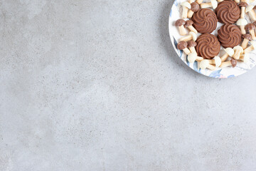 Fototapeta na wymiar Cookies and chocolate mushrooms on a plate on marble background