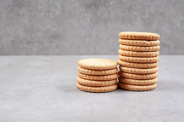 Two stacks of crispy biscuits on marble background