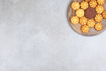 Cookies placed in star formation on a wooden tray on marble background