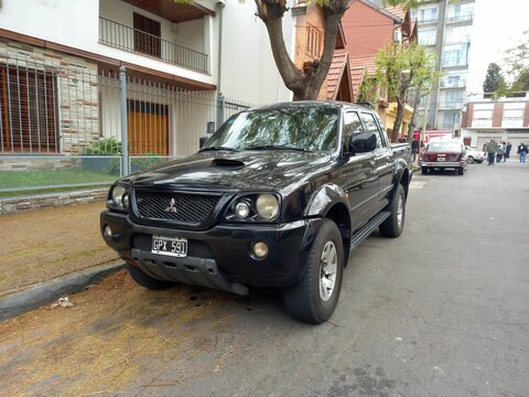 Utility Black 2000s Mitsubishi L200 Mighty Max 4x4 Pickup Truck In The Street. Classic Car Show.