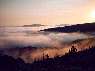 Cape Finisterre and its famous lighthouse surrounded by clouds and fog from the Atlantic Ocean.