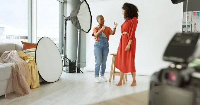 Photographer, model and idea with a black woman photography professional talking to female subject about a photo shoot in studio. Photograph, catalog and fashion with a fashion employee and talent
