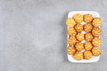 Delicious homemade cookies lined up on a plate on marble background