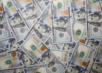 Fototapeta na wymiar A pile of new $100.00 USD bills or bank notes.