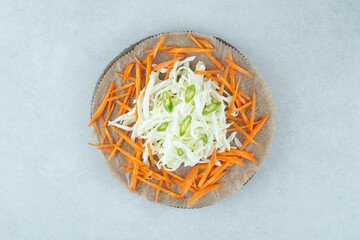 Julienned various vegetables on wooden piece