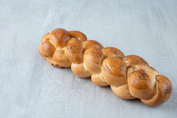 White braided bread on stone background