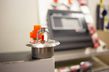 Fire alarm and mock sprinkler system attached to a white wall used for training