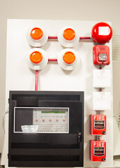 Fire alarm and mock sprinkler system attached to a white wall used for training